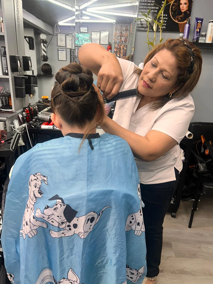 A stylist arranging a client’s hair at New Style